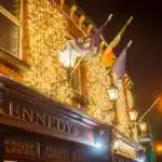 Connectable LED curtain lights 3m drop warm white on Kennedy's Pub Building side view