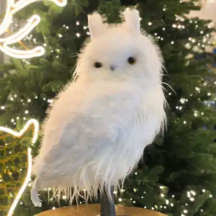 Furry long hair owl with pointed ears indoor Christmas decoration close up